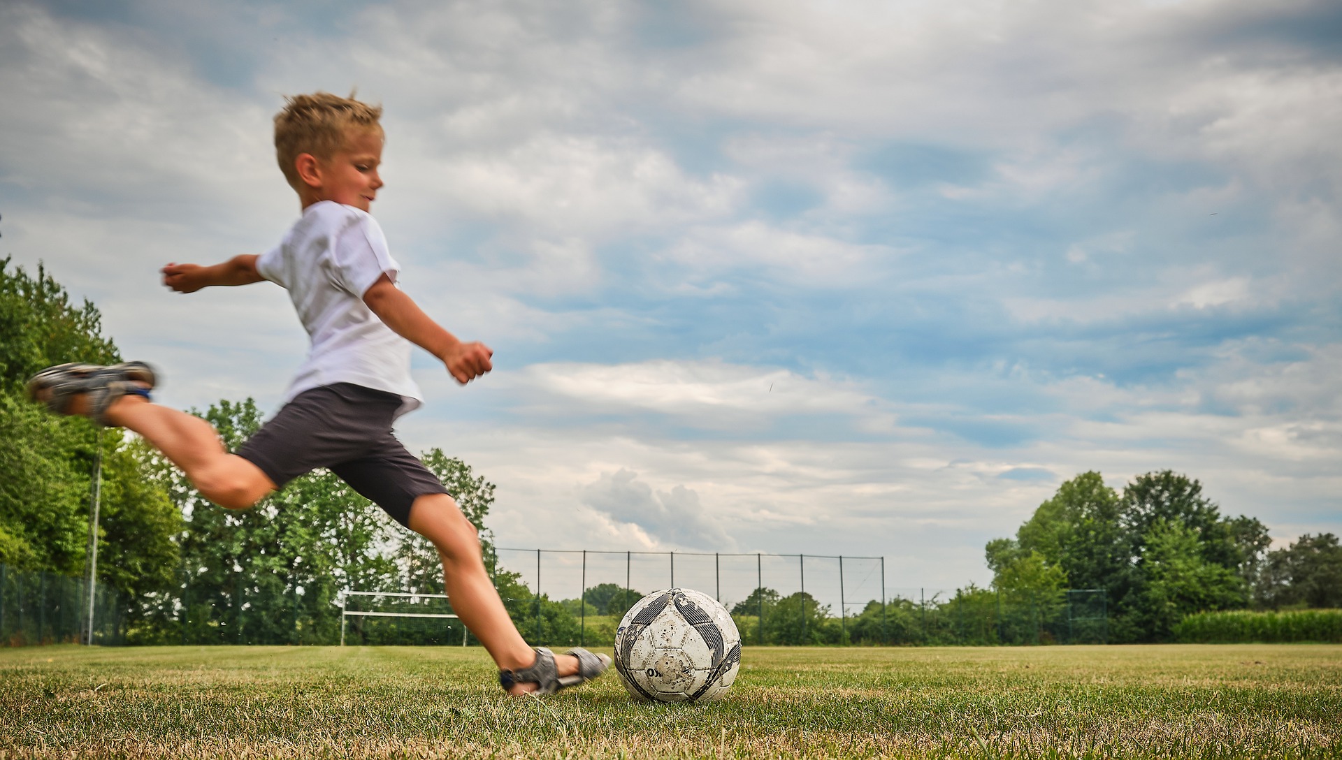 child plays football